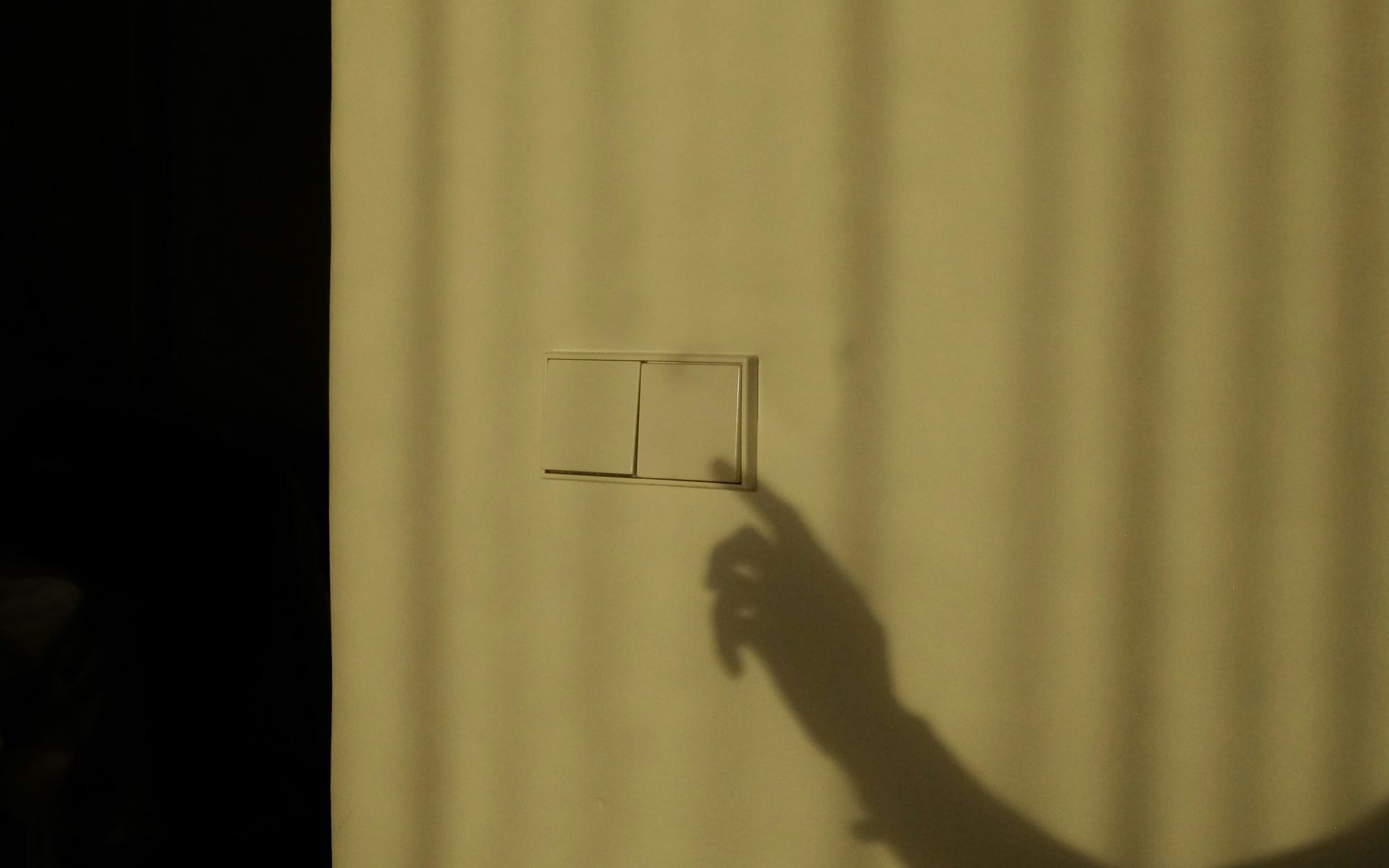 a shadow of a person holding a piece of paper